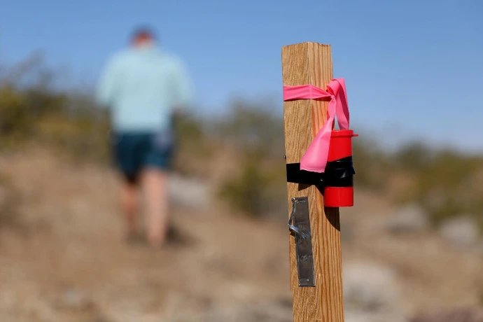 Wooden claim post with pink flagging tape at a mining claim in the Nevada desert